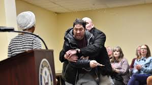 Rep. Ilhan Omar rushed by man on stage and sprayed with liquid at town hall event : NPR