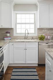 A Window Framed Partially By Light Gray Wall Paint And Light Brown Ceramic Backsplash Til Kitchen Remodel Countertops Kitchen Backsplash Designs Kitchen Design