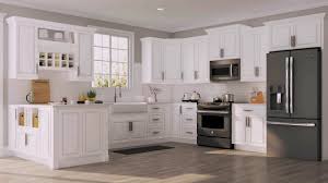 white kitchen cabinets with brass knobs