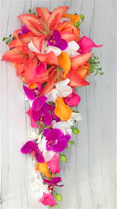 For a wedding bouquet with a bohemian, earthy vibe, your florist can use a mixture of peach garden roses, vanda orchids, carnations, and ranunculus in various shades of orange. Real Touch Tropical Orange Fuchsia And Off White Stargazers Orchids And Calla Lilies Silk Wedding Bouquet
