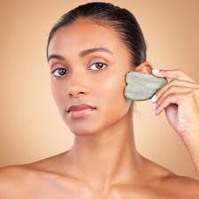 Beauty, Gua Sha and Portrait of Indian Woman for Skincare, Facial Treatment  and Wellness with Spa Tools. Salon Stock Photo