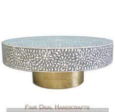 Whether the surface for a game night or just the perfect perch for keeping cups in easy reach, this coffee table is an essential place to gather in your living room ensemble. Handmade Bone Inlay Round Coffee Table In Floral Design With Brass Polished Base In Grey Color Fairdeal Handicrafts