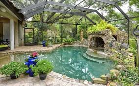 Glass Covered Pool Hot Tub Patio And Gardens Extending Directly Off The Home Hot Tub Enclosed In A Stone Cave Indoor Pool Design Backyard Pool Garden Pool