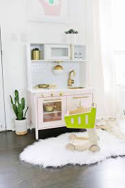 She lifted the cabinets from 16 off the counter to 27.5, creating more space underneath for additional shelving. Mid Century Modern Ikea Play Kitchen Hack A Beautiful Mess