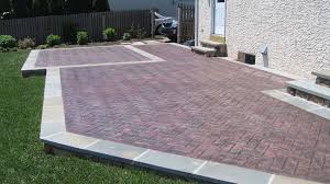 Bricks are laid in a narrow trench around the edge of a patio, which can also be made of brick, concrete, pavers, or other materials. Decorative Stamped Concrete Driveways Walkways And Patios Delaware