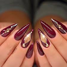 Nail art decoration with rhinestones and glitter. Red And Gold Acrylic Nails Coffin Nail And Manicure Trends