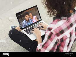 Young guy speaking to African American couple on webcam, using online video  chat on laptop, outdoors Stock Photo - Alamy