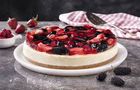 A baked cheesecake with a generous filling finished with a covering of berries: My Cafe Fruits Of The Forest Cheesecake Recipes Cakes In The Game My Cafe Recipes And Stories Or If You Prefer A Sweeter Top Crust Paint The Pie Crust With