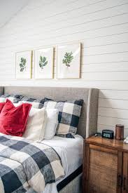 Natural linen chair and ottoman in a master bedroom corner beside a black wooden accent table and a pastel like abstract wall art in a gold frame. Diy Shiplap Accent Wall The Charming Detroiter