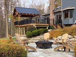 House exterior with large open deck with outdoor furniture. Hen House Decks Home Facebook
