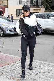 Black And White Varsity Jacket Outfit Rihanna Wearing Black And White Varsity Jacket Black Hoodie Black Skinny Jeans Black Leather Lace Up Flat Boots Skinny Jeans With Boots Rihanna Outfits Rihanna Style