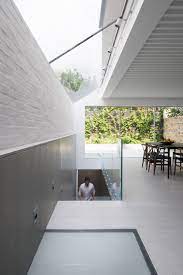 Taken from the inside, this lightwell runs the width of the property with walkable glass in the middle and a grille at either end, providing plenty of light and air. Lightwell House Leibal