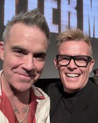 Robbie Williams photographed with his good friend (also a film director)  Stephen Ward last night… From Stephen Ward's page: 'Went to a screening of  Better Man, the highly unusual and brilliant biopic