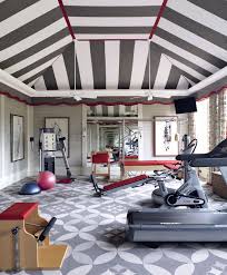 A desk, chair, drawers and artistic painting are the elements of this décor. 10 Home Gyms That Will Inspire You To Sweat Architectural Digest