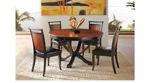 A curved pedestal base forms a streamlined silhouette that leads to a deeply recessed apron. Orland Park Black 5 Pc Round Dining Set Contemporary