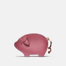 this peppy pig may not fly but he s awfully cute use this cheery refined leather case to carry keys spare change or apple leather coin purse pig bag purses