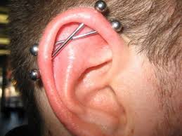 An industrial piercing consists of two holes through the cartilage of the ear, located opposite each other, connected by a bar. 15 Daring Industrial Piercing Ideas For Men Styleoholic