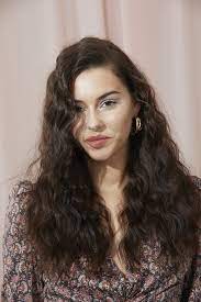 Create a small section that runs parallel to the part, lift it up, tease the base with two or three short strokes and hit the roots with a flexible hair spray. Thick Curly Hair 20 Easy And Modern Hairstyles We Love