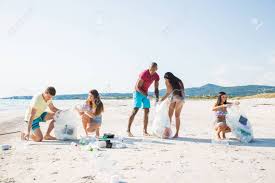 Group Of Activists Friends Collecting Plastic Waste On The Beach ...