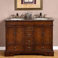 This raised panel bar features a worn look and a synthetic black leather armrest, accentuated with antique brass nailheads. Granite Top Bar Cabinet