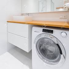 The laundry alternative is committed to delivering products that make life (and washing laundry) easier. White Bathroom With Wooden Countertop Basin Cabinet And Washer Stock Photo Picture And Royalty Free Image Image 93543803