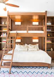 In a bunk bed, a bed with protective guard rails around it is installed on top of a regular bed, and can be accessed using a small ladder. Why Adult Bunk Beds Are A Design Do Architectural Digest