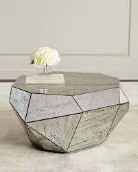 Anchor the living room with a modern coffee table. Dimensional Antiqued Mirror Coffee Table