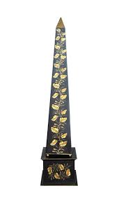 An Extremely Decorative Obelisk In Black Wax Aged Metal Decorated With Gilded Branches Of Oak Leaves And Acorns Dim 152x34x34 Cm Obeliscos
