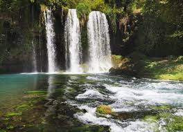 The white, foaming water of the manavgat waterfalls flows powerfully over the rocks. Antalya Duden Manavgat And Kursunlu Waterfalls