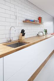 When you open the cupboards the worktop runs inside. Modern Kitchen Timber Wooden Worktop Sleek White Units No Handles White Tile Kitchen Decor Modern White Kitchen Wooden Worktop Modern Wooden Worktop
