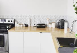 An awkward corner with a pink chair and a footrest, hanging wooden lamps and a side table for reading here. 6 Kitchen Corner Ideas To Maximise Your Space Burnhill Kitchens