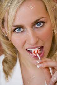 A Stunningly Beautiful Blue Eyed Blonde Haired Young Woman Sucking On A  Lollipop Stock Photo, Picture and Royalty Free Image. Image 862654.