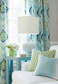 A red drum shaped stool sits below the tall window. 14 Design Sites You Have To See For Interior Color Curtains Living Room Blue And Green Curtains Living Room Turquoise