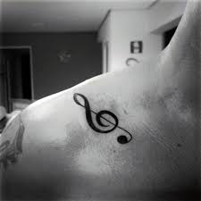 These music notes trail down the back in an elegant manner. 75 Music Note Tattoos For Men Auditory Ink Design Ideas