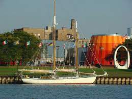 Sailboat On The Saginaw River With The Delta College Planetarium On The Right In Bay City Michigan Bay City Michigan Bay City Central Michigan