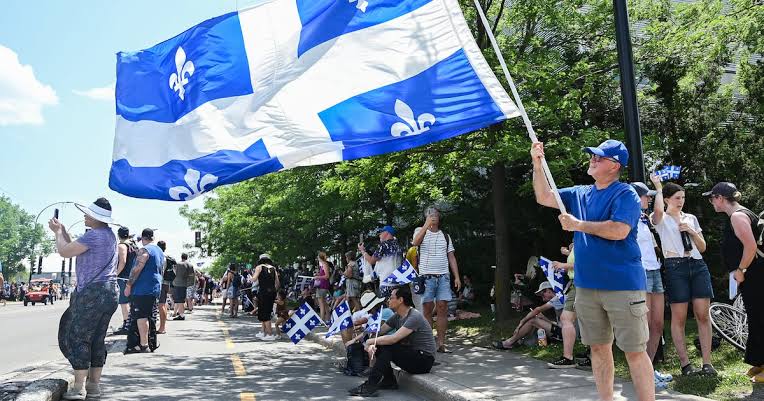 Fête Nationale: thousands brave sweltering heat in Montreal to show their  Quebec pride