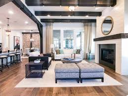 The masculine note is reflected in industrial influence lighting systems and materials used in finishes, such as natural stone on the walls and floor from travertine. Add Wood Beams To Your Home For A Bold Design With Neutral Colors
