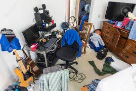 Messy, Cluttered Teenage Boys Bedroom With Untidy Piles Of Clothes ...