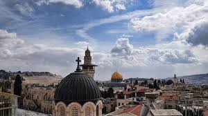 An arab woman holding up a flag in front of the dome of the rock on the temple mount, over two miles distant from paris square. Palestine Us Recognition Of Jerusalem As Israel S Capital Sabotages Prospects For Peace And Justice In The Region Cairo Institute For Human Rights Studies