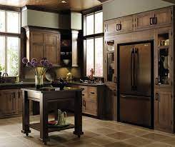 Complementing the grand window and clerestory, verticality is the unifying theme, in rich tones and accented by features such as corner shelving. Harmony Inset Cabinet Door Decora Cabinetry