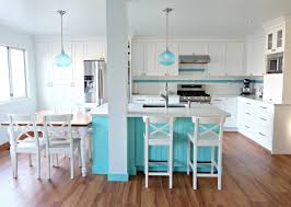 Modern white and turquoise kitchen interior with kitchenware, food containers and plant near brick wall. Turquoise Kitchen Renovation Part 4 It S All In The Details