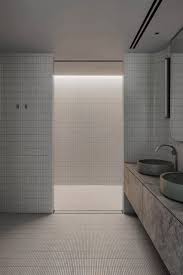 al bathroom is integrated into the back of this volume which is almost entirely covered with slim melbourne apartment white bathroom tiles apartment interior