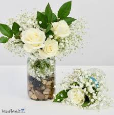 Light up your reception with a diy mason jar chandelier that features a wagon wheel as a base. Diy Fresh Flower Rustic Wedding Centerpieces For Under 25
