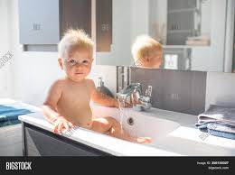 Baby gatsby taking a bath in the kitchen sink having a fun time! Baby Taking Bath Sink Image Photo Free Trial Bigstock