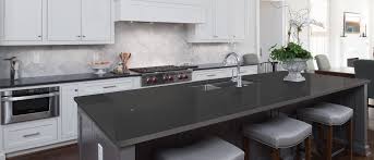 Mystery white leathered kitchen with waterfall island and full height backsplash. Quartz Countertops Shadow Gray Quartz Q Premium Natural Quartz