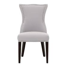 Elegant symmetrical living room style features gray velvet roll arm sofas with nailhead trim decked with animal print and floral accent pillows. Ivory Camel Back Nailhead Dining Chair