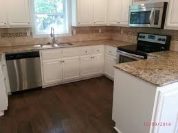 We contracted with home depot for purchase and installation of floor tile and countertops. Trafficmaster Hand Scraped Saratoga Hickory 7 Mm Thick X 7 2 3 In Wide X 50 5 8 In Length Laminate Flooring 24 17 Sq Ft Case 34089 The Home Depot Kitchen Remodel Home Flooring