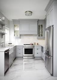 10 design ideas to steal for your tiny kitchen 10 photos. This Gray U Shaped Kitchen Features A Gray Paneled Hood Flanked By Antiqued Mirrored Kitchen Cab Mirrored Kitchen Cabinet Kitchen Layout Kitchen Cabinet Design