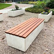 The bench is made out of concrete with the seating crafted out of cherry wood with a red tint, providing a. Outdoor Seating For Manchester University
