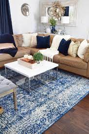 Hm They Used A Tan Leather Couch Which Is What We Have Blegh But They Played It Up Re Rugs In Living Room Tan Couch Living Room Leather Couches Living Room